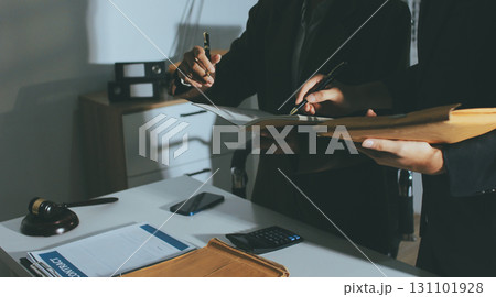Lawyer explained to the client about the law that must be brought against the court case. 131101928