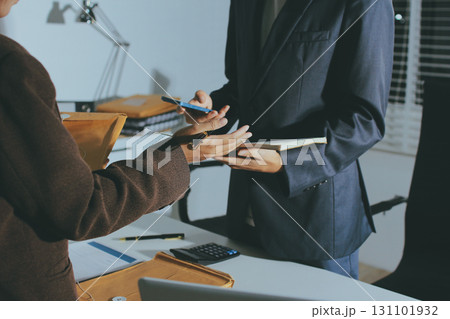 Lawyer explained to the client about the law that must be brought against the court case. Lawyer explained to the client about the law that must be brought against the court case. 131101932