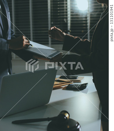 Lawyer explained to the client about the law that must be brought against the court case. Lawyer explained to the client about the law that must be brought against the court case. 131101941