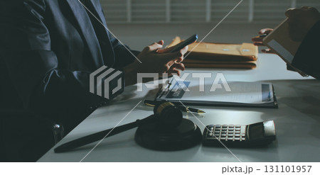 Lawyer explained to the client about the law that must be brought against the court case. Lawyer explained to the client about the law that must be brought against the court case. 131101957