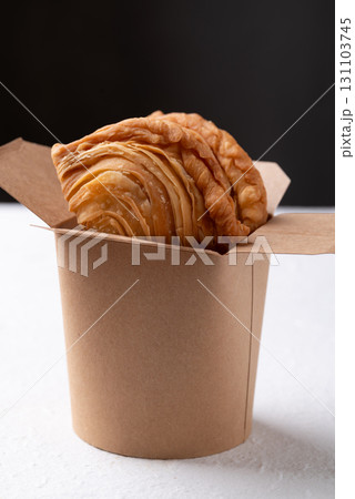 Curry puff stuffed with chicken or sweet potatoes in paper food box Curry puff stuffed with chicken or sweet potatoes in paper food box 131103745