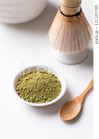 Matcha green tea powder with bamboo whisk and bowl on white background Matcha green tea powder with bamboo whisk and bowl on white background 131103785