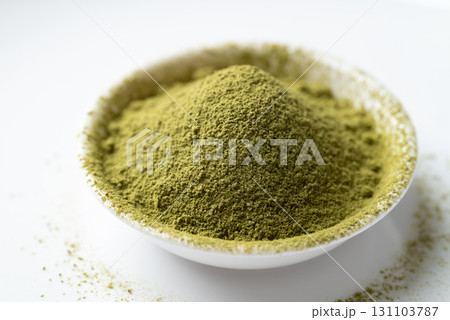 Matcha green tea powder in bowl on white background Matcha green tea powder in bowl on white background 131103787