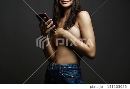 Sexy young smiling Woman. Happy topless Girl with smartphone Sexy young smiling Woman. Happy topless Girl with smartphone 131103926