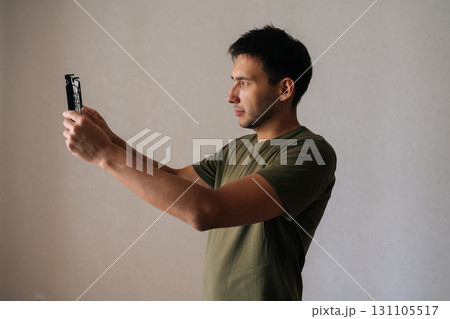Side view of technician male carefully inspecting and cleaning air humidifier filter, ensuring clean and healthy air in home environment, performing regular maintenance for optimal performance. 131105517