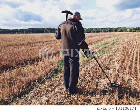 man in a field with a metal detector. Metal detector in action, Treasure hunt. man in a field with a metal detector. Metal detector in action, Treasure hunt. 131106171