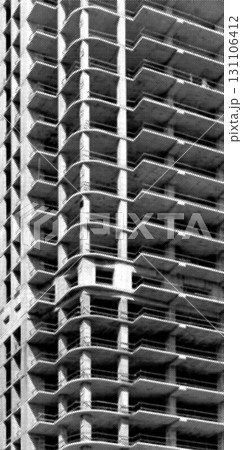 Construction of high rise tower. Exposed concrete framework with rough pattern, balconies, and Construction of high rise tower. Exposed concrete framework with rough pattern, balconies, and 131106412