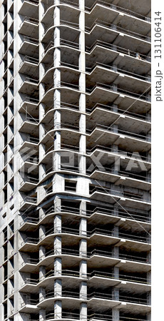 Construction of modern skyscraper. Tall condominium with geometric framework and balconies, Construction of modern skyscraper. Tall condominium with geometric framework and balconies, 131106414