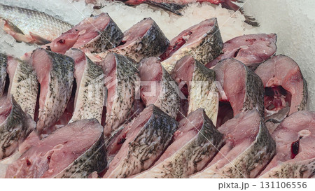 Frozen sea and freshwater fish on a supermarket shelf Sliced and whole Seafood Frozen sea and freshwater fish on a supermarket shelf Sliced and whole Seafood 131106556