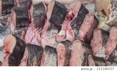 Frozen sea and freshwater fish on a supermarket shelf Sliced and whole Seafood 131106557