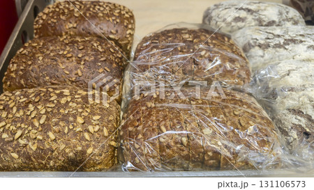 Bread and rolls on display at the store. Freshly baked goods for sale. Bread and rolls on display at the store. Freshly baked goods for sale. 131106573