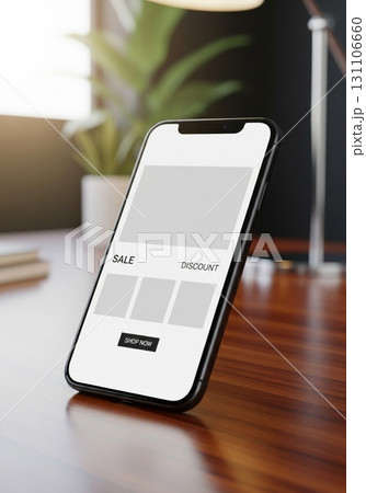 Smartphone Displaying Blank White Screen on Wooden Desk with Blurred Background 131106660