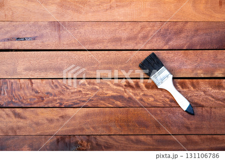 Paint brush and wood material in construction work. 131106786