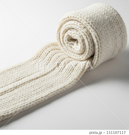 Cream Colored Knitted Wool Scarf Rolled on White Seamless Background 131107117