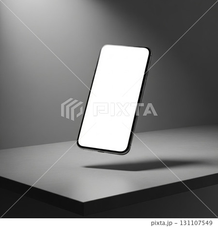 Elevated Smartphone on Gray Surface Mockup with White Screen in Studio Lighting 131107549