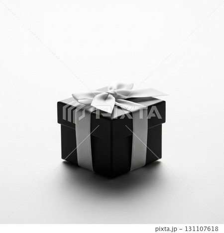 Elegant Black Gift Box with Silver Ribbon on White Gradient Background 131107618