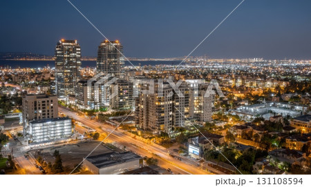 Stunning Night Skyline View of Urban City with Lights and Buildings Reflecting on a Beautiful Evening Sky 131108594