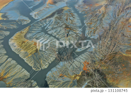 Aerial view of colorful contaminated cyanide residuals waters from gold mine. Abstract nature pattern Aerial view of colorful contaminated cyanide residuals waters from gold mine. Abstract nature pattern 131108745