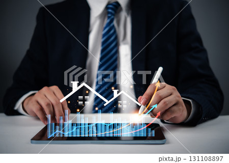 Businessperson analyzing real estate market growth and property data. Great for property investment, real estate market analysis, and business development in housing. Businessperson analyzing real estate market growth and property data. Great for property investment, real estate market analysis, and business development in housing. 131108897