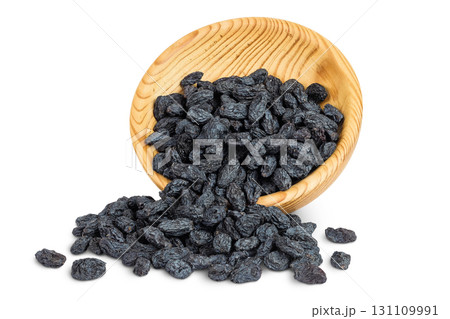 black raisins in wooden bowl isolated on white background black raisins in wooden bowl isolated on white background 131109991