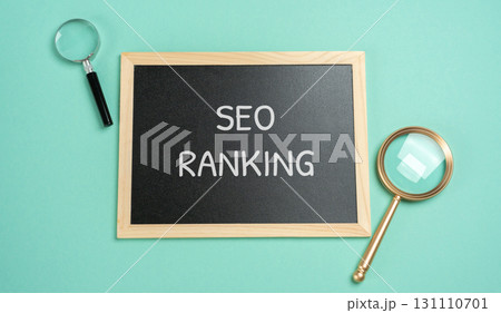 Board with words SEO ranking. Position a website or webpage holds in the search engine results pages (SERPs) for a specific keyword or phrase. Concept of internet and technology Board with words SEO ranking. Position a website or webpage holds in the search engine results pages (SERPs) for a specific keyword or phrase. Concept of internet and technology 131110701