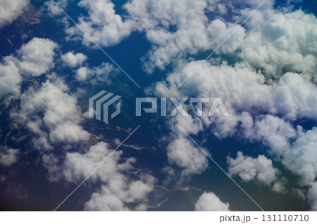 Aerial view of white fluffy clouds over landscape Aerial view of white fluffy clouds over landscape 131110710
