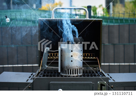 Smoking charcoal starter in outdoor grill 131110711