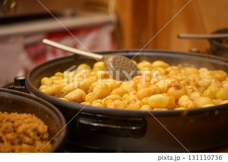 Traditional street food with fried potatoes at Christmas market Traditional street food with fried potatoes at Christmas market 131110736
