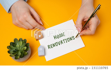 Home renovations. Process of improving, updating, or restoring a home by making structural, cosmetic, or functional changes to enhance its value, appearance, or comfort. Woman points to a message 131110765