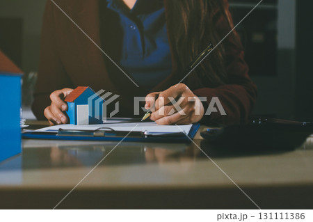 Customer signing a real estate contract in real estate agency. 131111386