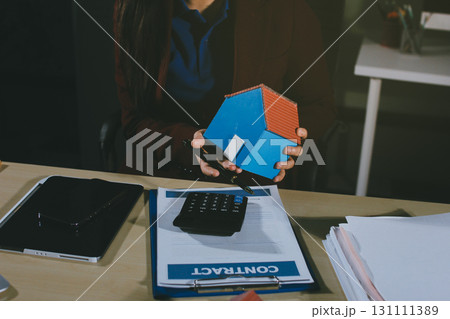 Customer signing a real estate contract in real estate agency. Customer signing a real estate contract in real estate agency. 131111389
