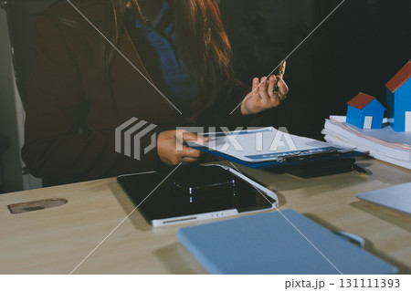 Customer signing a real estate contract in real estate agency. Customer signing a real estate contract in real estate agency. 131111393