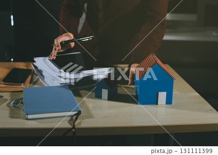 Customer signing a real estate contract in real estate agency. 131111399