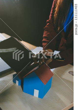 Customer signing a real estate contract in real estate agency. Customer signing a real estate contract in real estate agency. 131111403