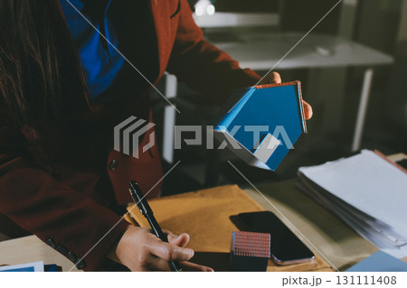 Customer signing a real estate contract in real estate agency. Customer signing a real estate contract in real estate agency. 131111408