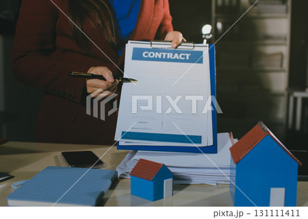 Customer signing a real estate contract in real estate agency. Customer signing a real estate contract in real estate agency. 131111411