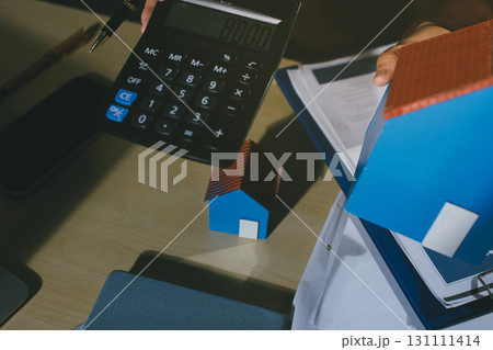 Customer signing a real estate contract in real estate agency. 131111414