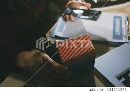 Customer signing a real estate contract in real estate agency. Customer signing a real estate contract in real estate agency. 131111421