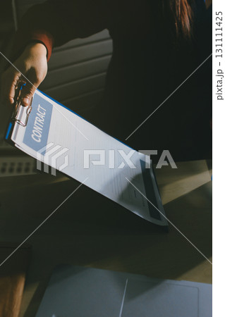 Customer signing a real estate contract in real estate agency. Customer signing a real estate contract in real estate agency. 131111425