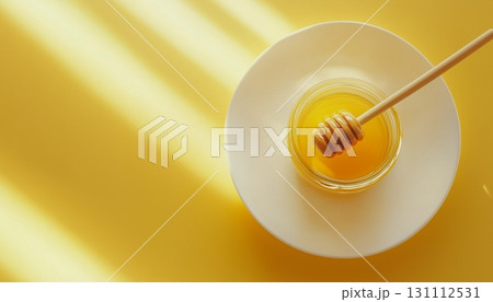 Honey bee on glass jar and white plate for natural organic sweetener 131112531