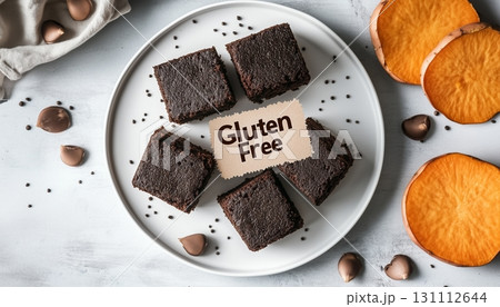 Gluten free brownie cake chocolate slice on white plate with sweet potato flour 131112644