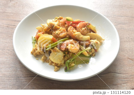 stir-fried spicy squid with shrimp salty egg and sauce on plate stir-fried spicy squid with shrimp salty egg and sauce on plate 131114120