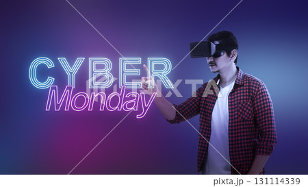 Indonesian southeast asian man in virtual reality glasses touching a text of Cyber Monday on a color gradient background. Copy space. Cyber Monday sale concept Indonesian southeast asian man in virtual reality glasses touching a text of Cyber Monday on a color gradient background. Copy space. Cyber Monday sale concept 131114339
