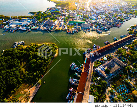 Aerial view of residential houses and driveways neighborhood during a fall sunset or sunrise time.Tightly packed homes.Top view over building houses in phuket thailand 131114449