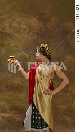 Man in toga presenting burger on hand with serious confident posture 131115421