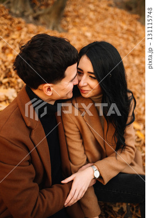 Young couple in love walking in the park on a autumn day. Enjoying time together. 131115748