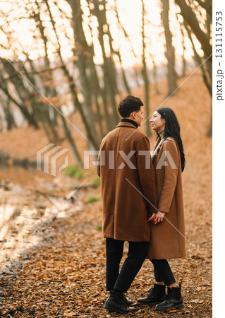Young couple in love walking in the park on a autumn day. Enjoying time together. 131115753