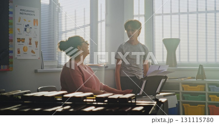 Talented Boy Singing Song During Vocal Lesson. Music Teacher Playing Piano, Supporting Young Student Talented Boy Singing Song During Vocal Lesson. Music Teacher Playing Piano, Supporting Young Student 131115780