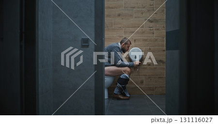 Businessman Using Smartphone, Sitting on the Toilet, Scrolling Social Networks Businessman Using Smartphone, Sitting on the Toilet, Scrolling Social Networks 131116027