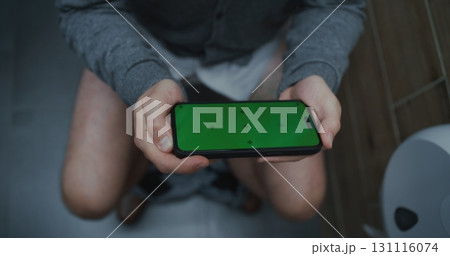 Male Office Worker Sitting on Toilet, Using Phone with Chroma Key Male Office Worker Sitting on Toilet, Using Phone with Chroma Key 131116074
